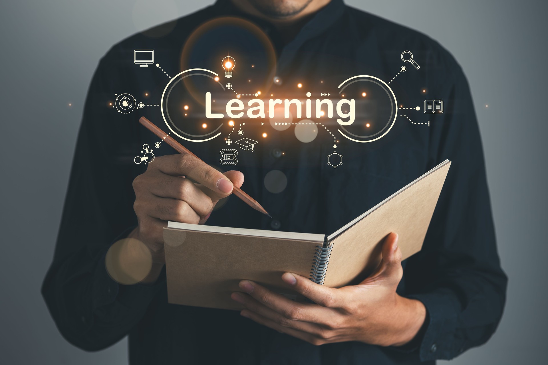 Businessman learning and writing on book. knowledge and online education concept